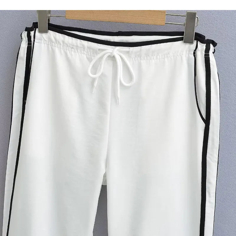 Women's loose straight leg trousers with ribbon parallel bars contrast colour detail on low waist, in thin fabric.