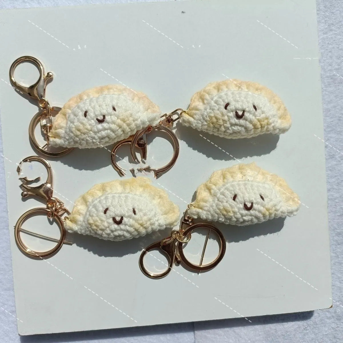 Handmade crochet dumpling pendant with keychain showing plush texture and hand-stitched decorative eyes