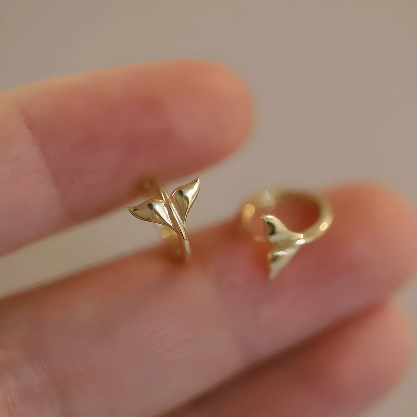 Pair of S925 sterling silver fishtail earrings with 14k gold plating in gold colour.