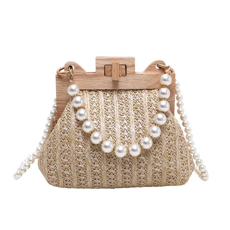 Women's beige straw woven shoulder bag with pearl chain strap, showing horizontal square shape and sewing line detail.