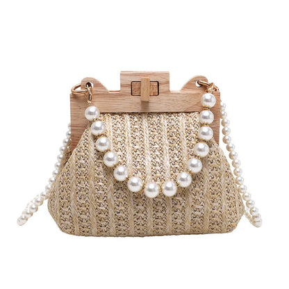 Women's beige straw woven shoulder bag with pearl chain strap, showing horizontal square shape and sewing line detail.