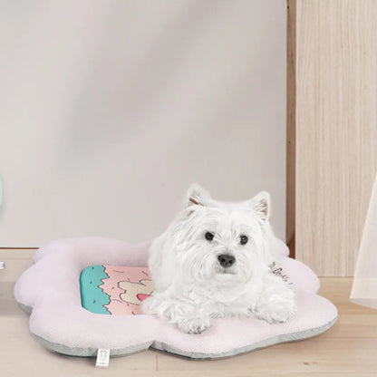Green and pink pet cooling mats for dogs and cats in four different sizes on a wooden floor.