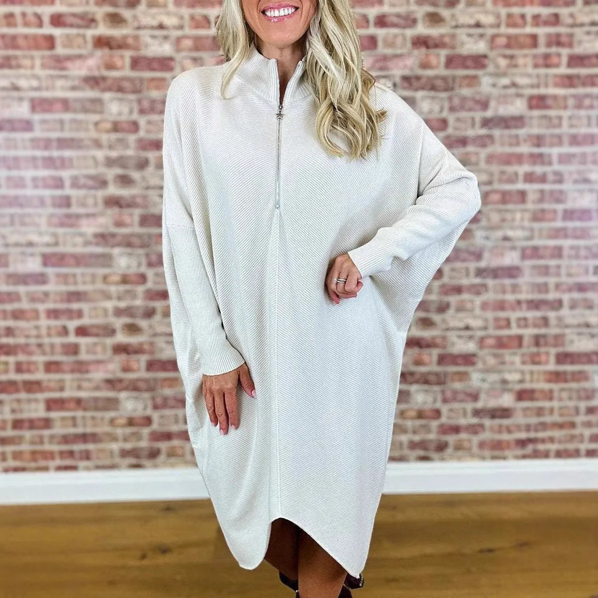 Women's solid colour loose fit knitted dress with raglan sleeves and a front zipper.