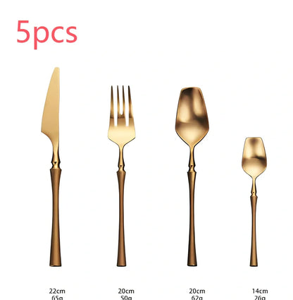 Four-piece stainless steel cutlery set showing main knife, fork, spoon, and teaspoon with mirror finish