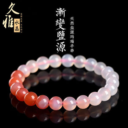 Natural gradient Yanyuan agate bracelet with geometric beads on a white background.