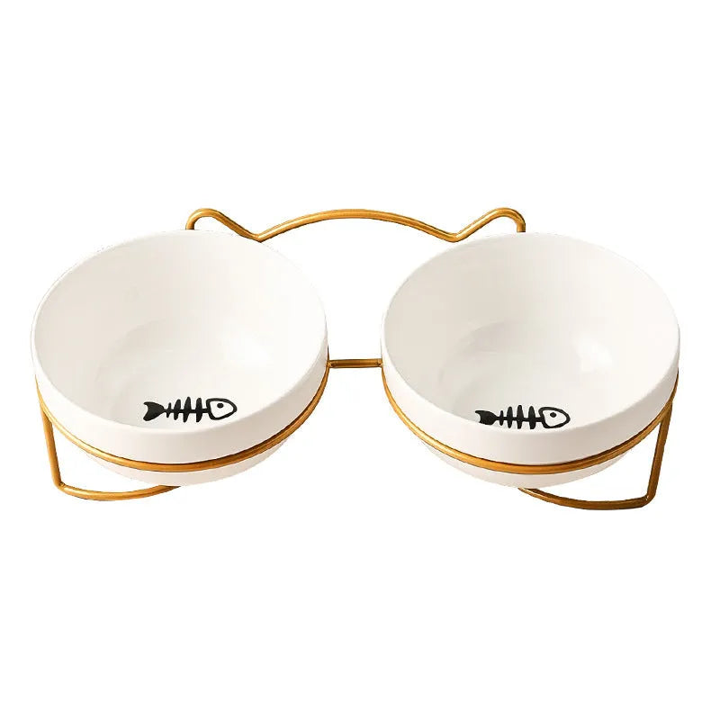 White ceramic pet bowl with cat paw design on a black iron frame raised feeder.