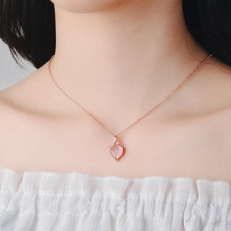 Women's heart-shaped pink crystal pendant necklace with rose gold finish and cross chain