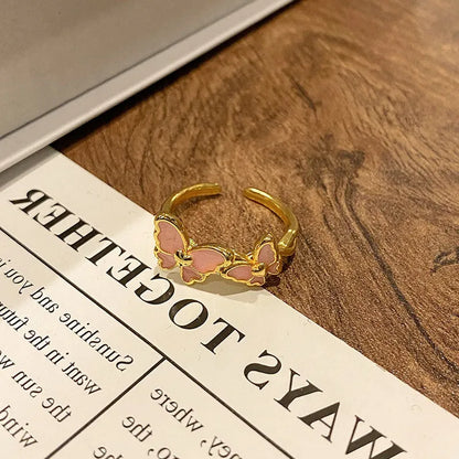 Copper women's ring with Chinese butterfly design and adjustable open loop.
