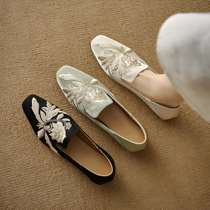 Women's black embroidery retro flat pumps with round toe and shallow-mouth design on a soft sole.