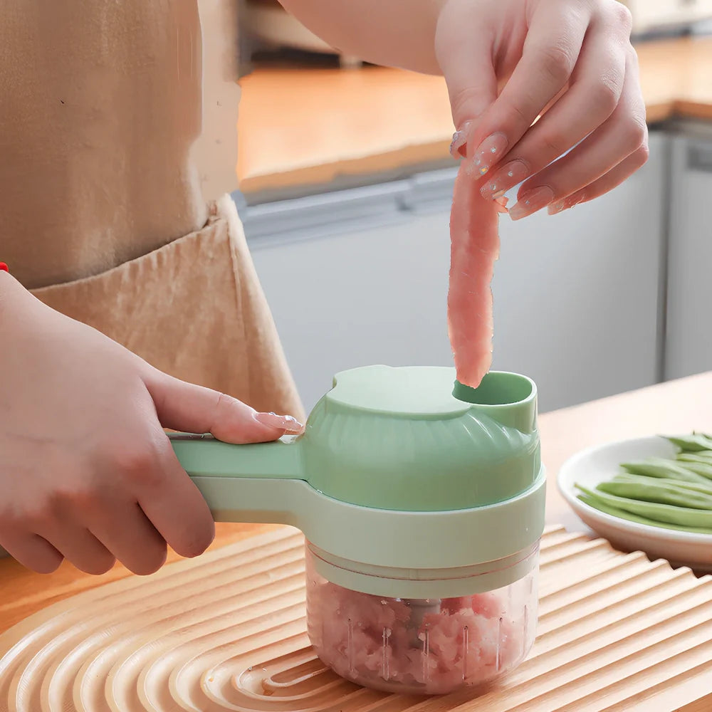 Green wireless vegetable cutter with stainless steel blade and transparent container for food processing