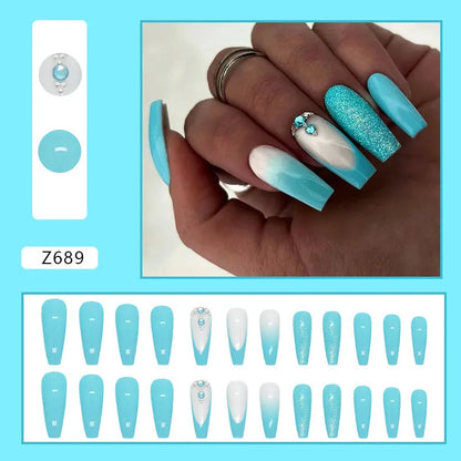 Solid blue glitter ballet-style artificial nail patches and glue bottle arranged on a table.