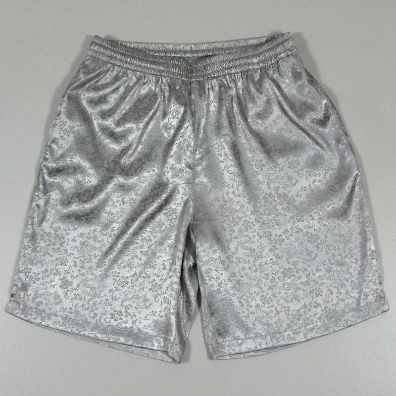 Men's black Tai Chi shorts with a white drawstring elastic waistband laid flat.