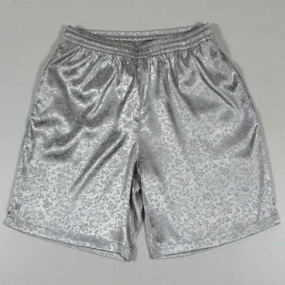 Men's black Tai Chi shorts with a white drawstring elastic waistband laid flat.