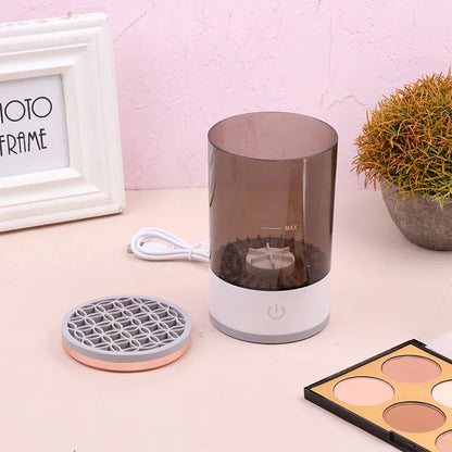 Grey and white portable electric makeup brush cleaner with USB charging cable.