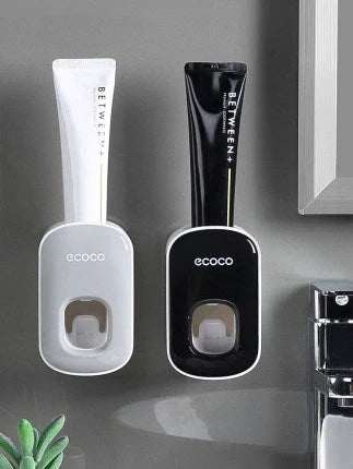Wall-mounted automatic toothpaste dispenser with toothbrush holder and storage organizer, available in black and grey colors