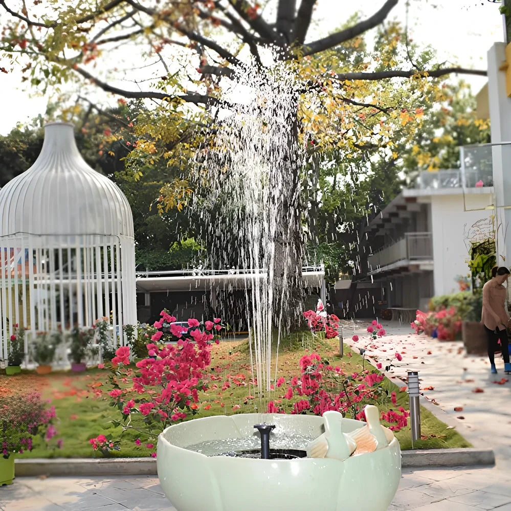 Black solar fountain with water spray in garden pond showing 55cm height and four nozzle options