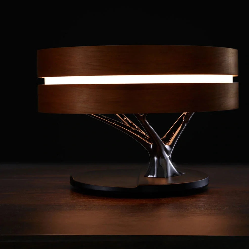 Round Bluetooth speaker with LED tree lighting and wireless charging surface in maple brown finish