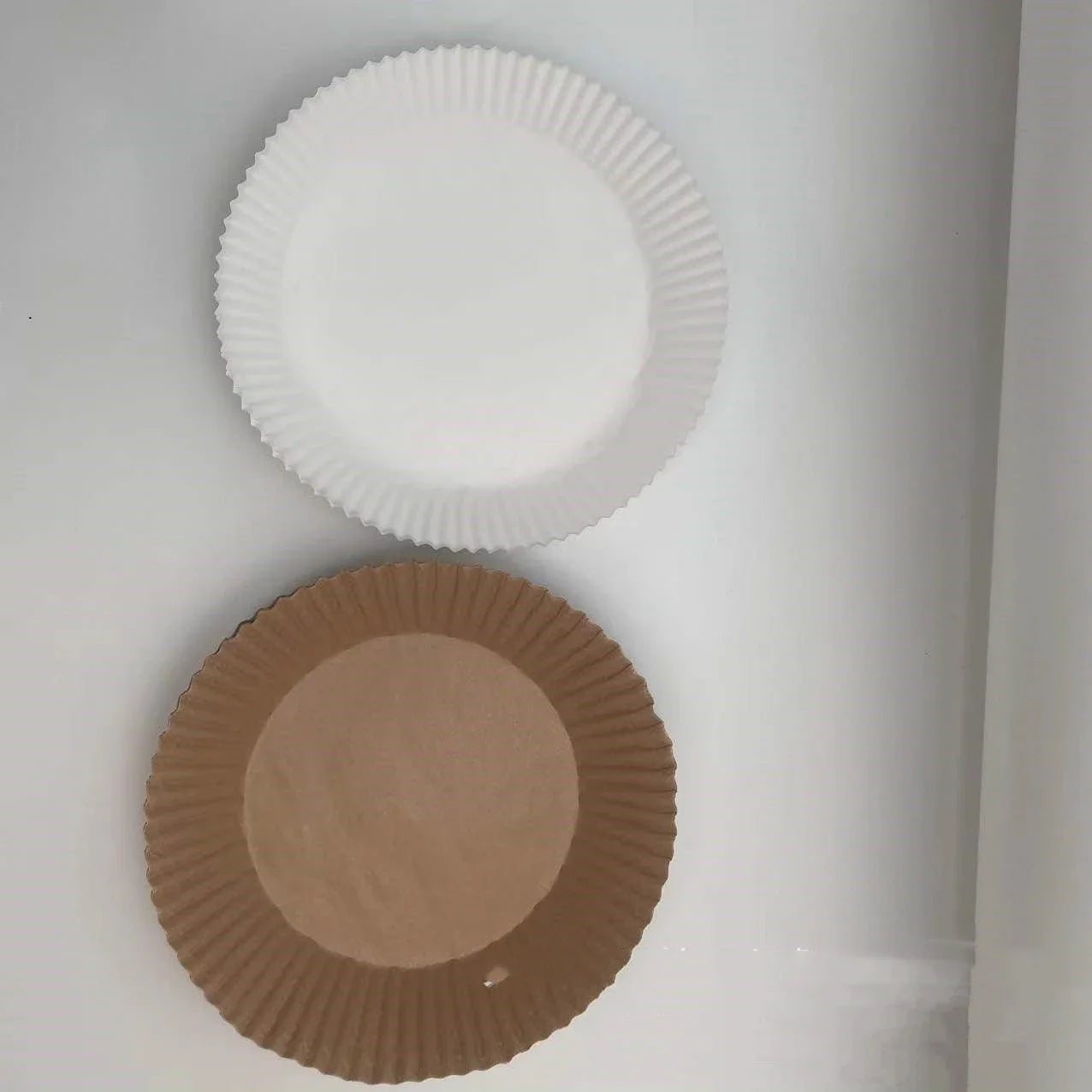 Disposable air fryer liners made of durable, food-grade parchment paper for effortless cleanup and healthy cooking