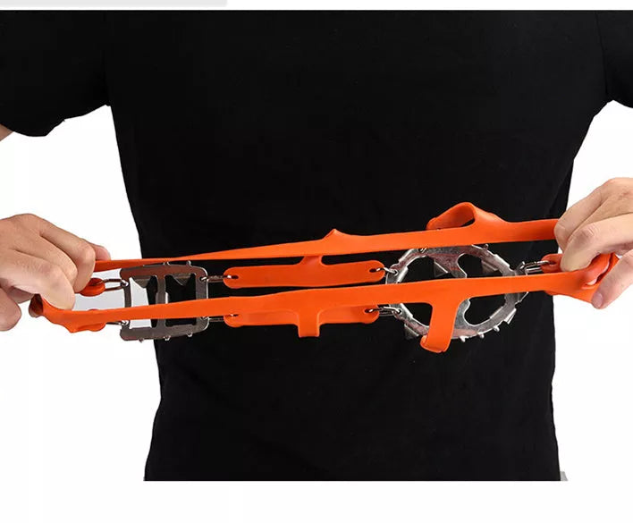 Reinforced large-tooth non-slip shoes in black and orange for superior traction on slippery surfaces