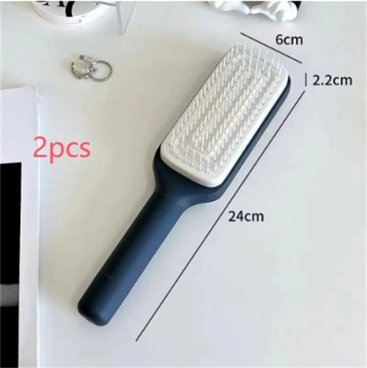 Roland Purple self-cleaning hair brush with rotating telescopic handle and anti-static bristles.