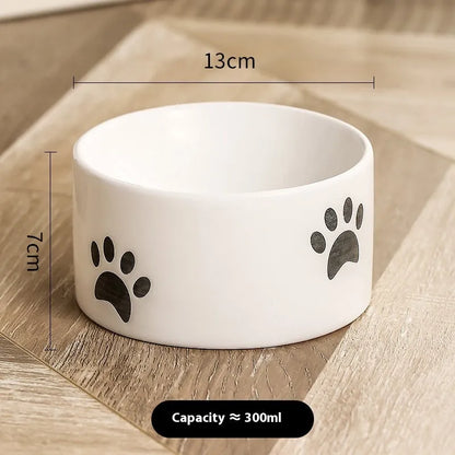 Ceramic cat bowl with high foot and cat's paw base in an oblique mouth design.