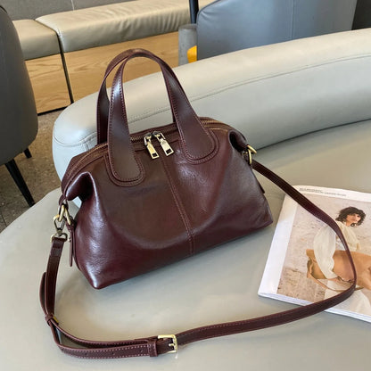 Soft pillow-shaped top grain leather handbag, 30cm x 13cm x 22cm, with double straps and inner patch pocket