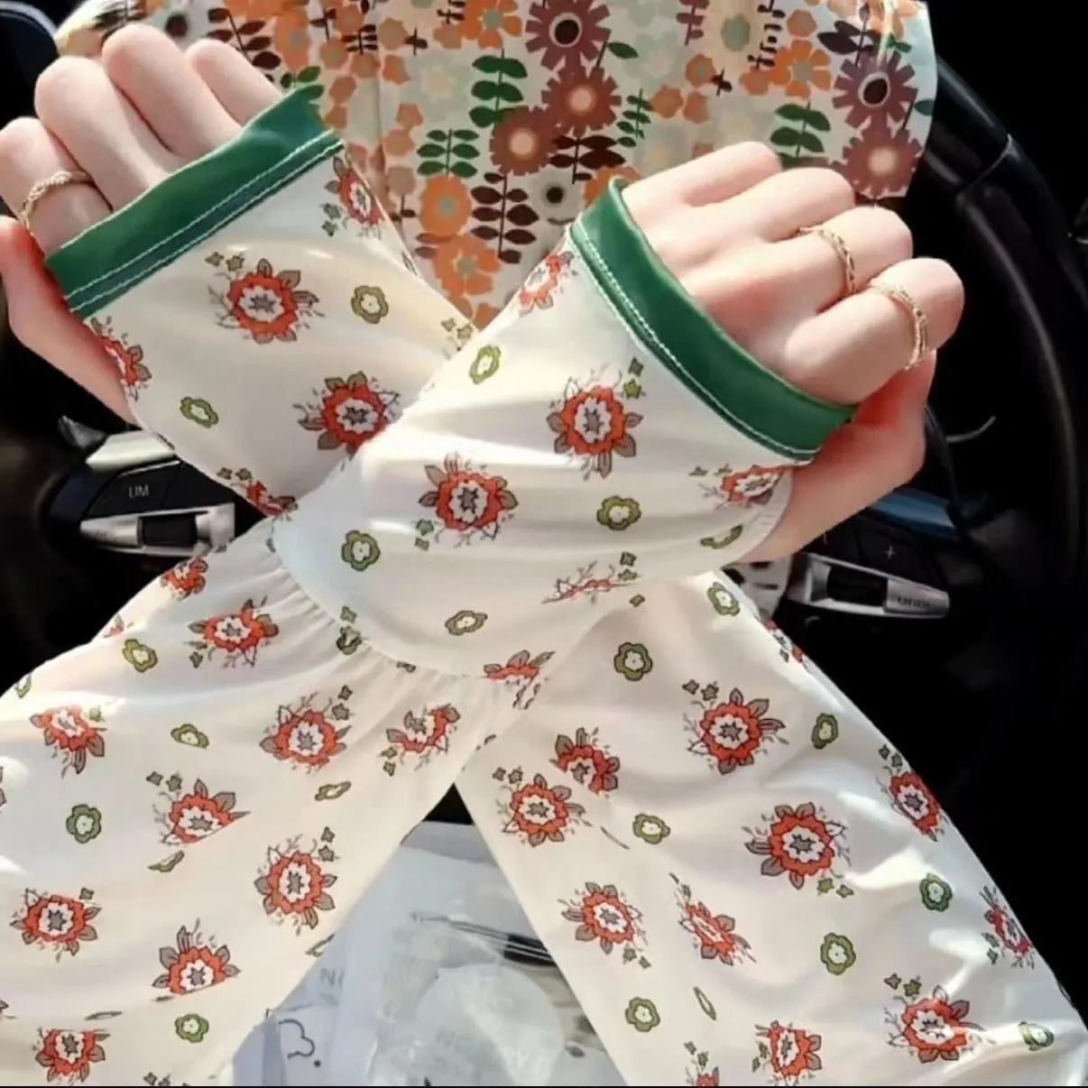 UV protection ice silk oversleeves in floral pattern covering forearm and elbow