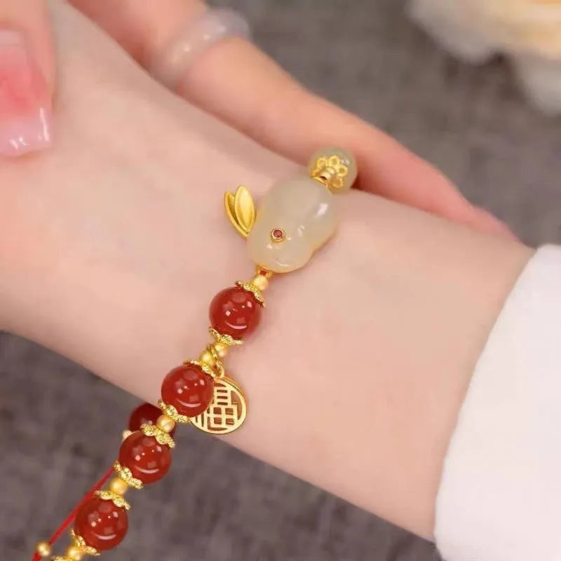 Chinese style glass bead bracelet with bamboo joint design on wrist.