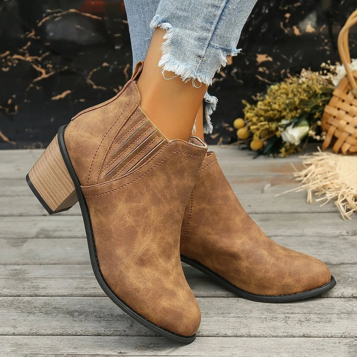 Black and brown women's ankle boots with a pointed toe and thick square low heel, slip-on design.
