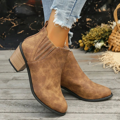 Black and brown women's ankle boots with a pointed toe and thick square low heel, slip-on design.