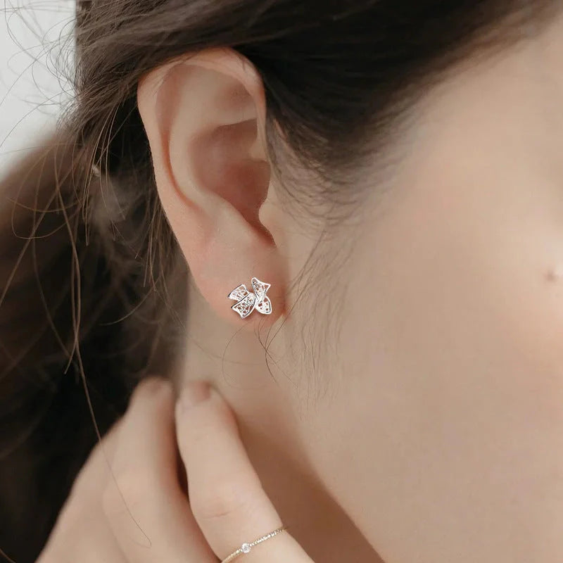 Elegant silver bow stud earrings for women, hypoallergenic and perfect for any occasion.
