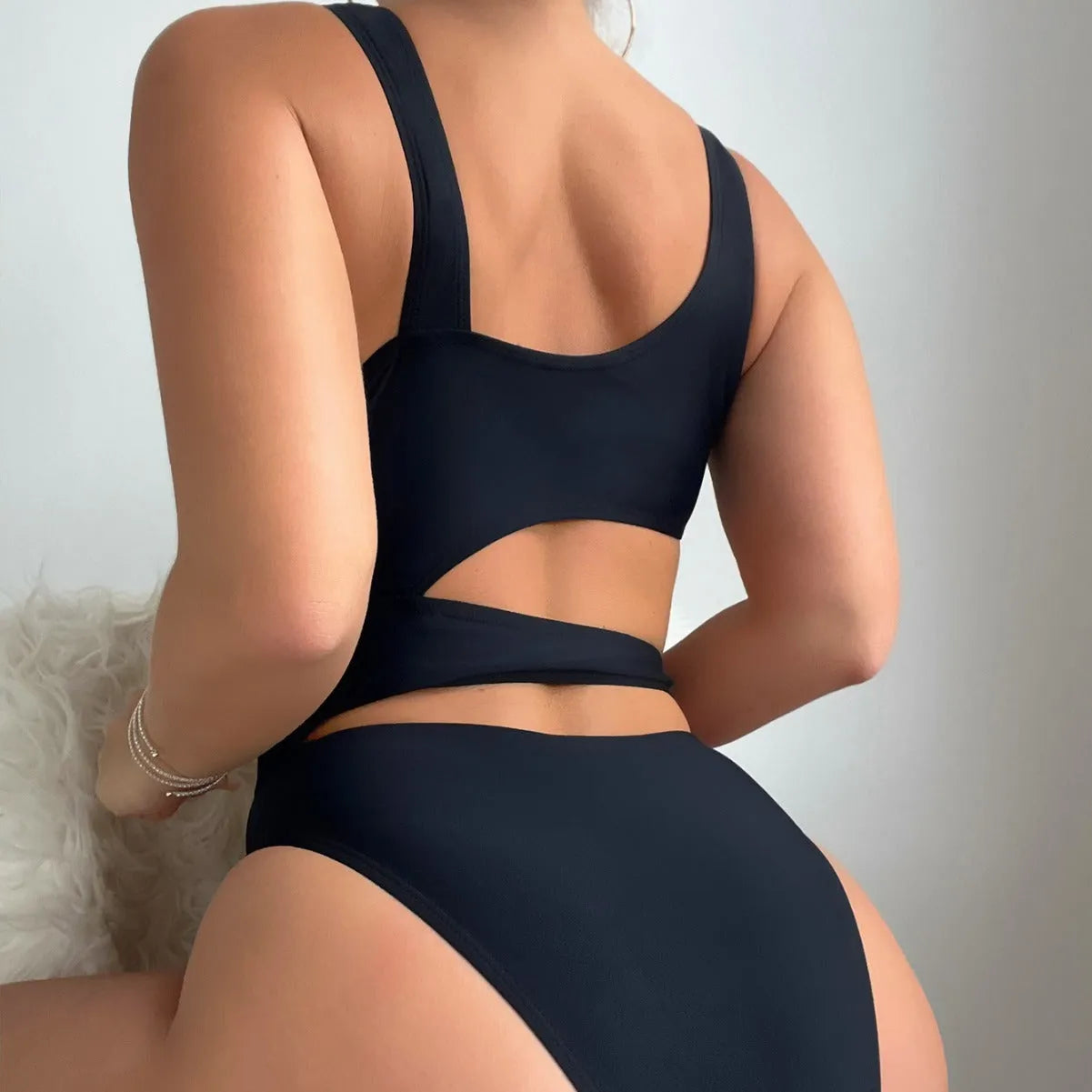 Black high-cut women's one-piece swimsuit with sleeveless design