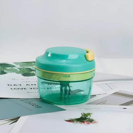 Green manual food chopper with pull cord, stainless steel blade, and 300ml transparent container.