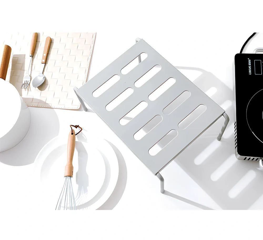 Grey retractable kitchen shelf with hollow grid design extended to 45cm width