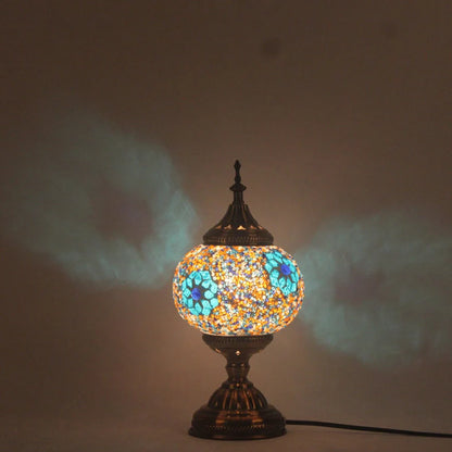 Glass table lamp with 150mm diameter shade and 330cm cord on wooden surface