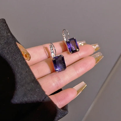 Women's square crystal earrings in copper with purple, red, and yellow colour options measuring 25mm by 10mm.