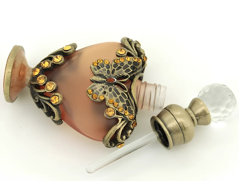 Heart-shaped refillable perfume bottle with metal and crystal construction, 3.6 inches tall