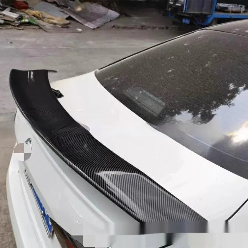 Car punch-free spoiler in ABS plastic showing adhesive mounting surface and finish options