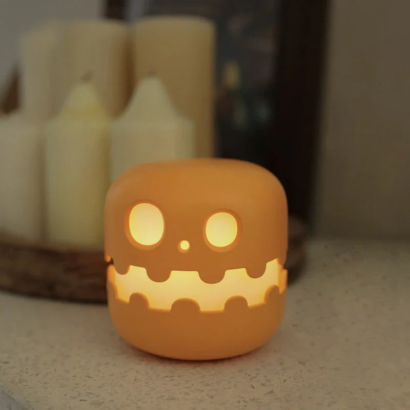 Pumpkin-shaped nightlight with soft silicone construction and warm, soothing glow for creating a cozy Halloween atmosphere