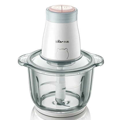 Household electric vegetable chopper blender with glass bowl and stainless steel blade on kitchen counter