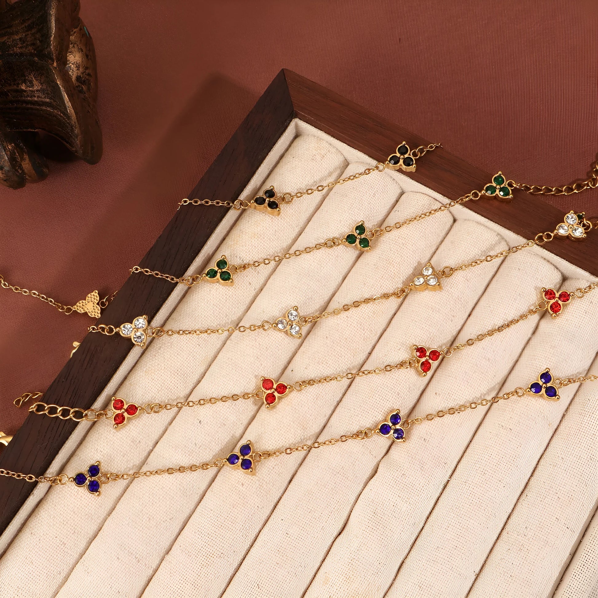 Women's stainless steel bracelet with three triangle-shaped charms in different coloured stone settings