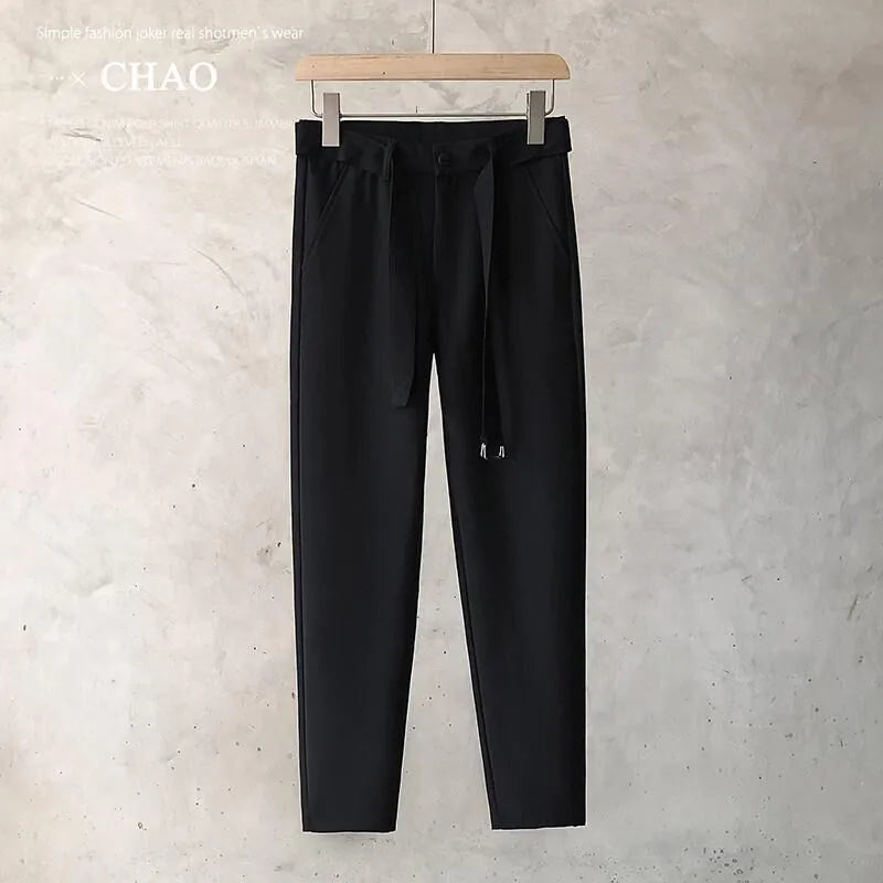 Boys slim straight wool trousers in a tapered fit, shown in a light grey colour.
