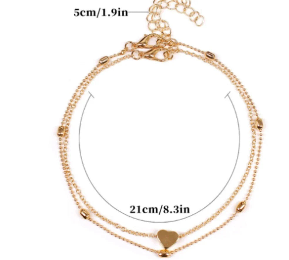 Trendy heart-shaped anklet with double-layered design and retro beach ball chain in gold, silver, and silvery colors.