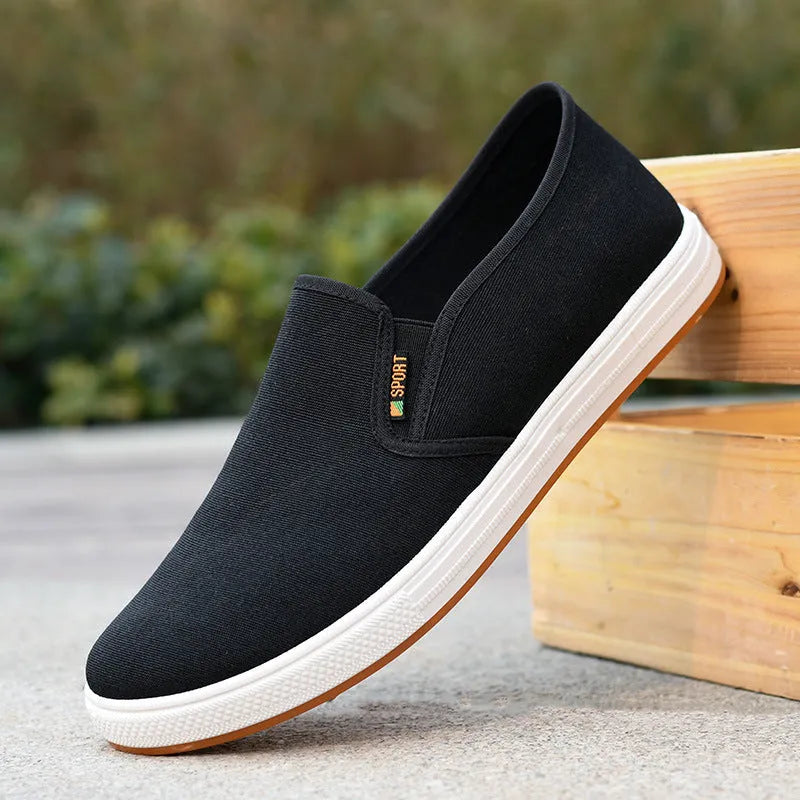 Men's low-top slip-on canvas casual shoes in black with a round toe and composite sole.