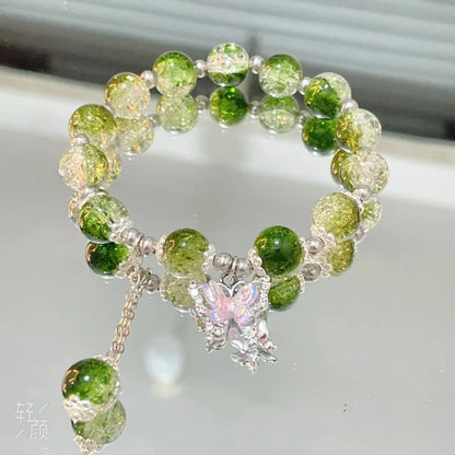 Chinese style glass bead bracelet with bamboo joint design on wrist.