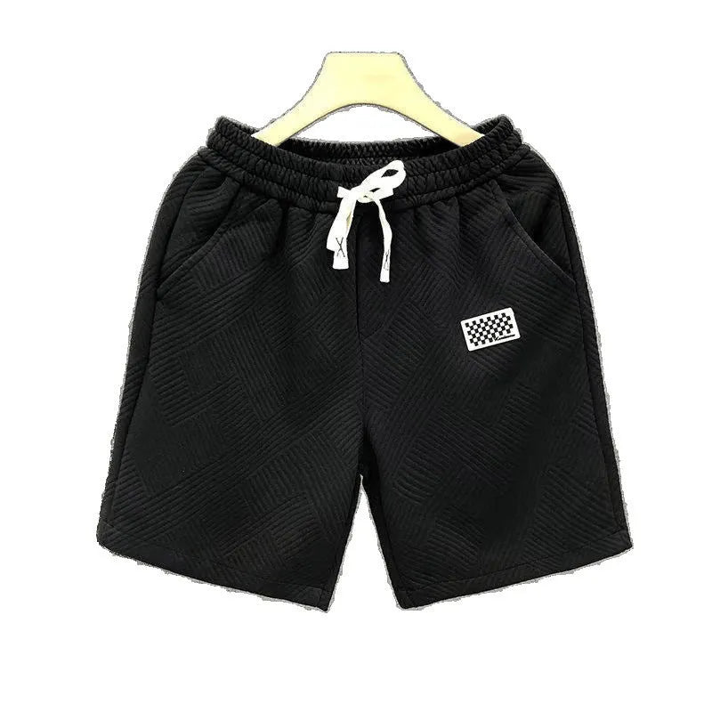 Man's solid colour casual sports shorts in micro-elastic polyester fabric on a beach background