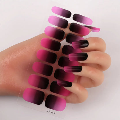 Sheet of 16 small design nail art stickers including cross, rose, tulip and marble patterns.