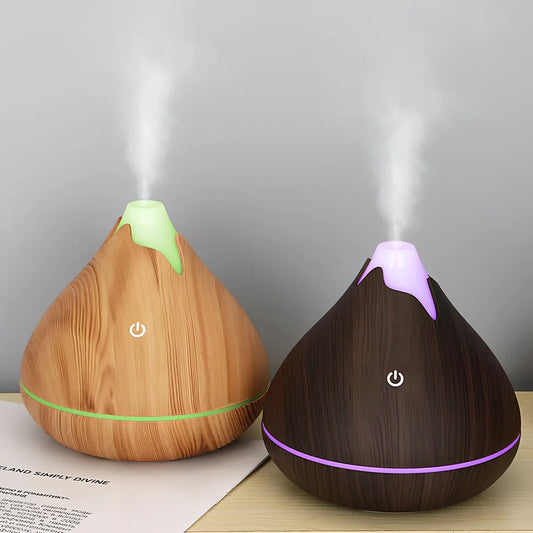 Round wood grain humidifier with USB cable and single mist outlet on light oak finish