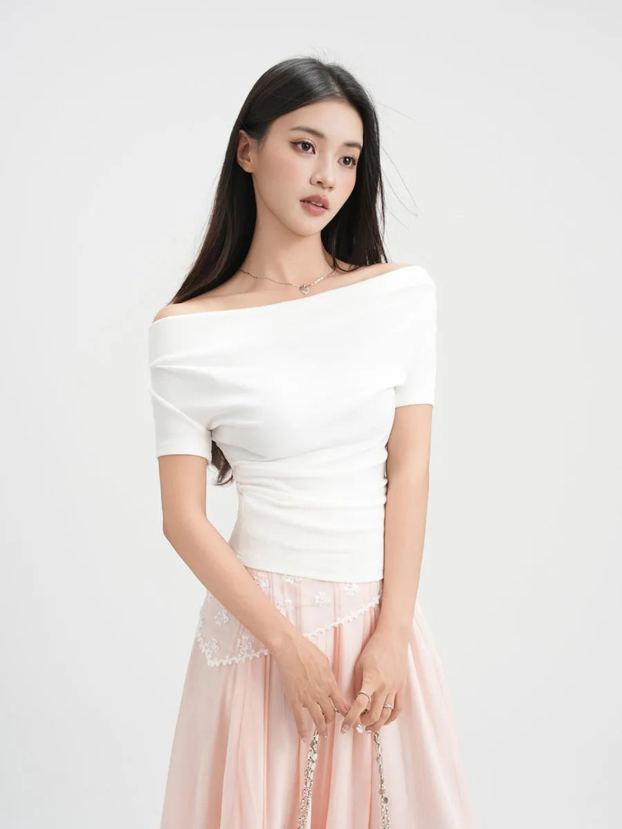 Women's one-shoulder draped neckline short sleeve top in slim fit with pleat detail, shown in Apricot