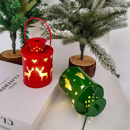 Green wrought iron electronic candle lantern with flickering LED light on a wooden mantel.